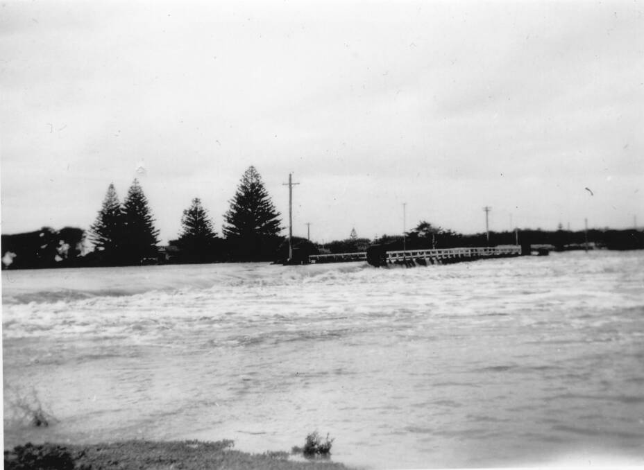 Floodwaters inundating a bridge in Port Fairy. Picture: Port Fairy Historical Society 