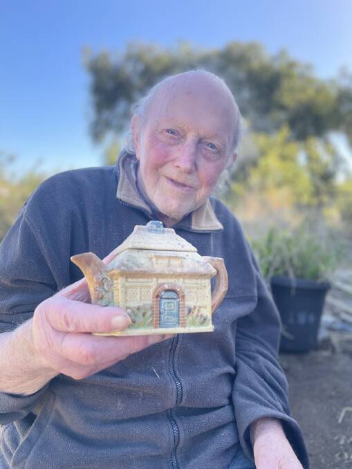 Bruce Clark with the teapot house that he pulled from the ashes. Picture by Katrina Lovell