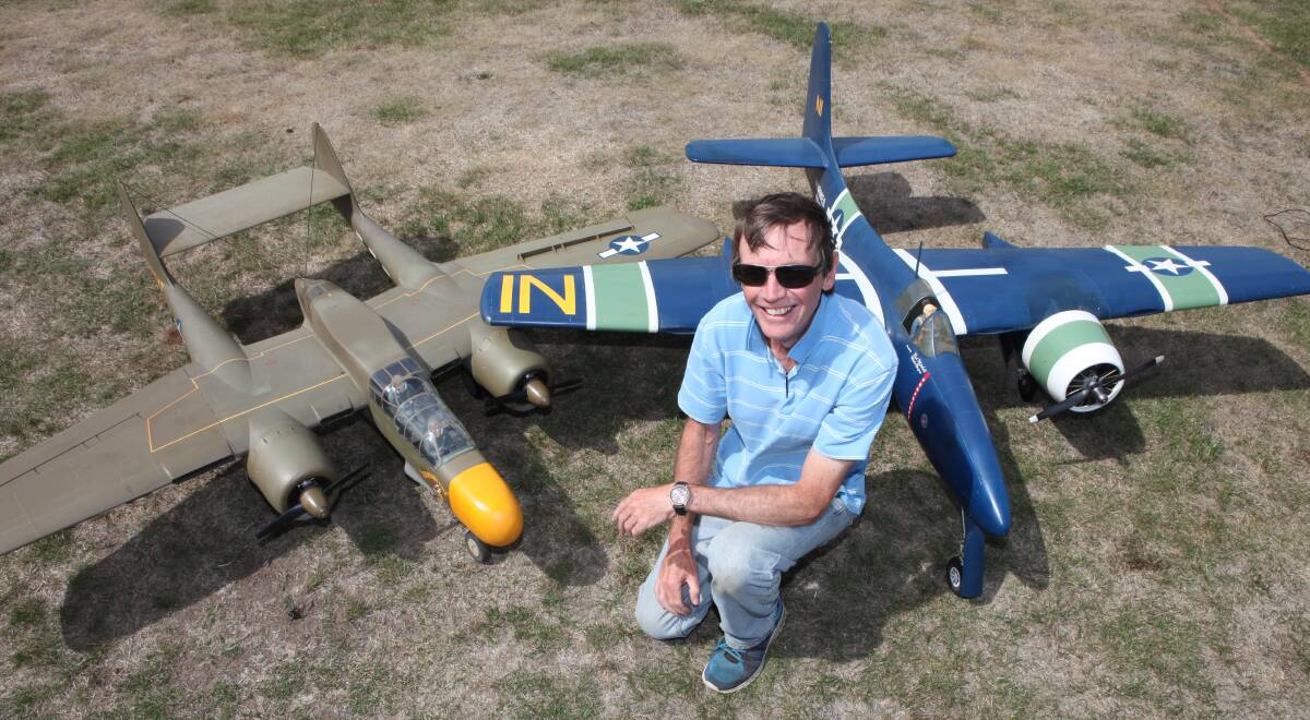 Flight plan: Rod Mitchell with his replica Black Widow and Tigercat model aeroplanes that he has designed and made from scratch.