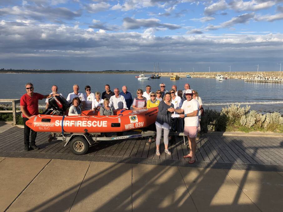 Upgrade: The Lions Club of Warrnambool hands over a new Inflatable Rescue Boat to surf life saving club vice-president John McNeil.