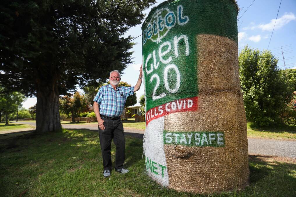 Staying safe: In the spirit of COVID-19, Colin Huf shows off one of the hay bale creations which was decorated as a can of Glen 20. Pictures: Morgan Hancock