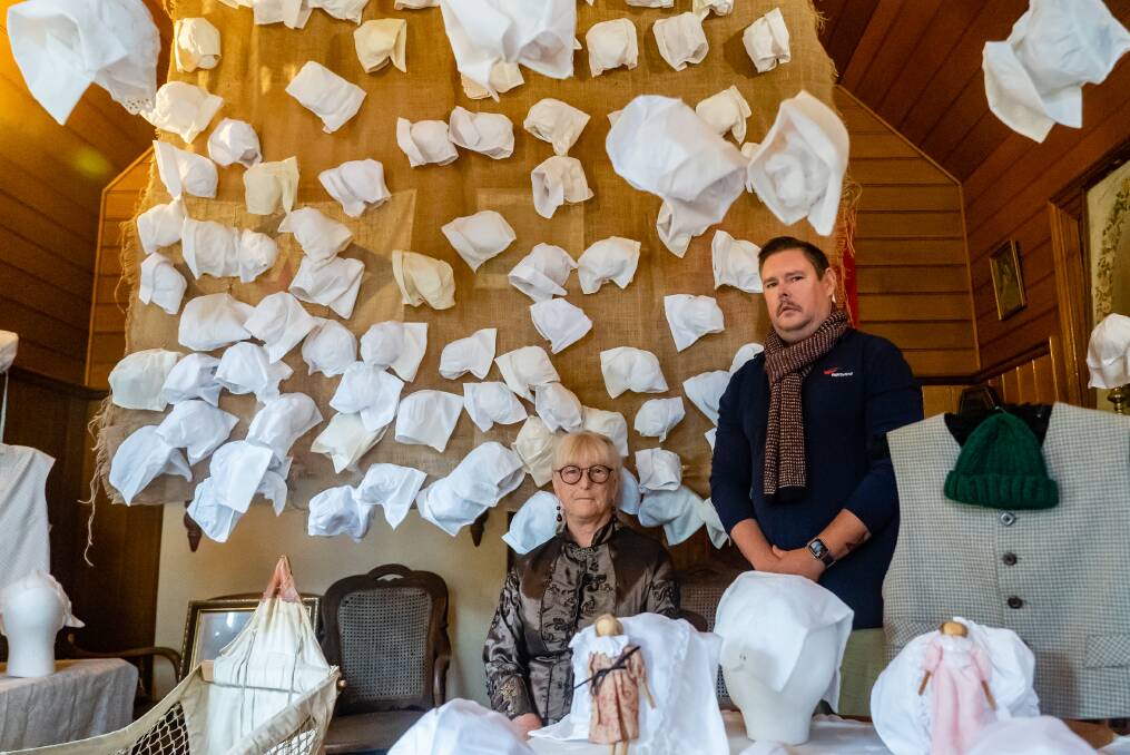 Tribute: Volunteer Pat Zaunbrecher and curator Justin Croft with the exhibition to those who lost their lives in one of Australia's worst ever maritime disasters.