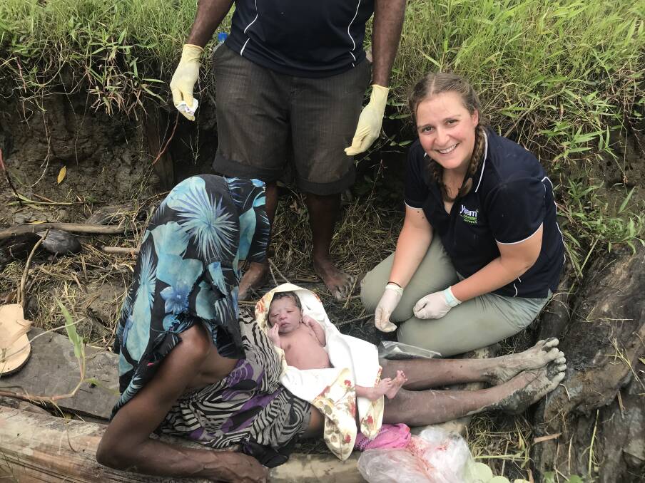 Memorable: Rachel Bakker helps deliver a baby by the edge of a river in PNG.