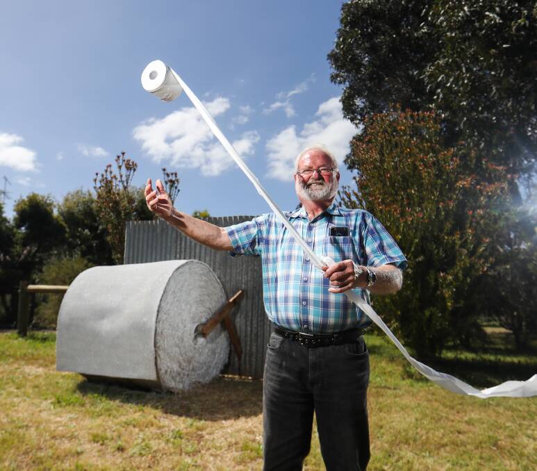 On a roll: Colin Huf with the Tarrington hay bale art that pays tribute to one of 2020's most unusual crisis - the toilet paper shortage. Pictures: Morgan Hancock
