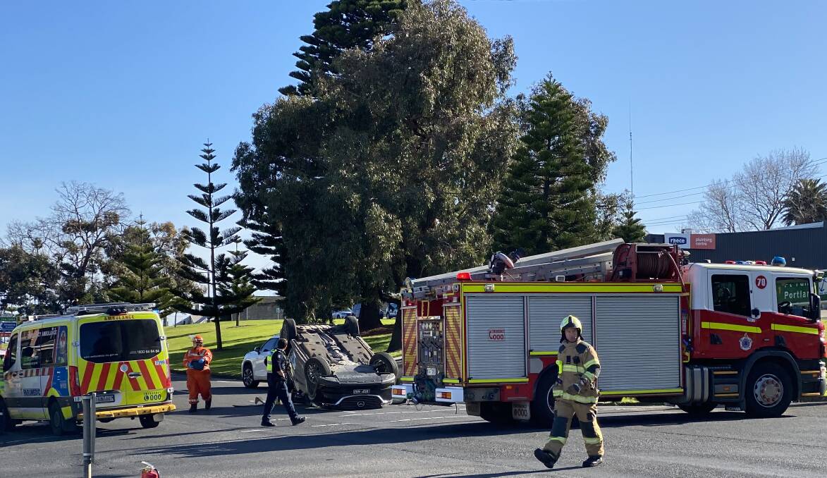 Emergency services worked to free the occupants of a car that flipped on Raglan Parade this morning.