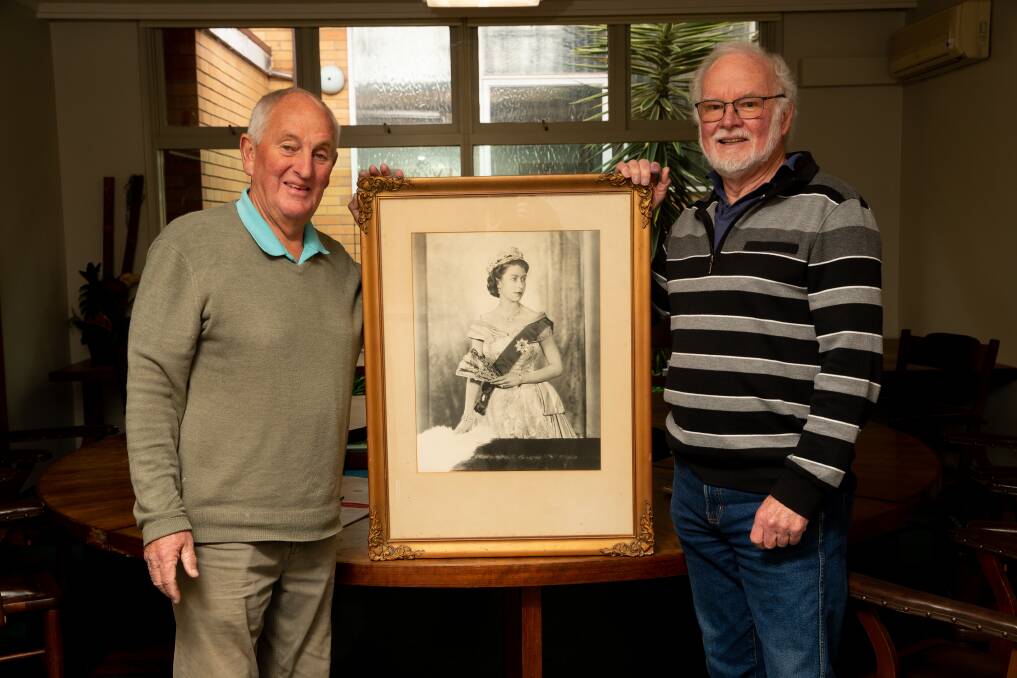 Cobden Civil Hall committee management members Milton Parlour and Frank Martin are wondering when to switch to a portrait of the new king. Picture by Chris Doheny 