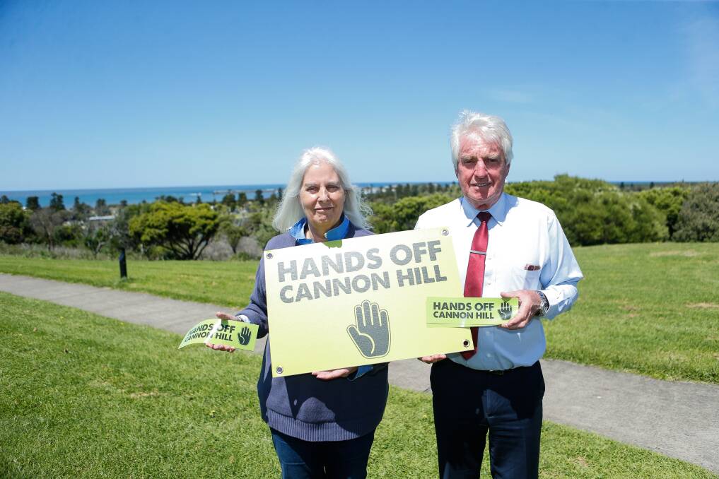 Tricia Houghton and Brian Guyett with the corflutes and bumper stickers that send a message to council that they want Cannon Hill left as it is. Picture by Anthony Brady