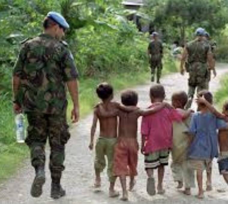 Troops looking after children in Timor Leste during the conflict in the late 1990s.