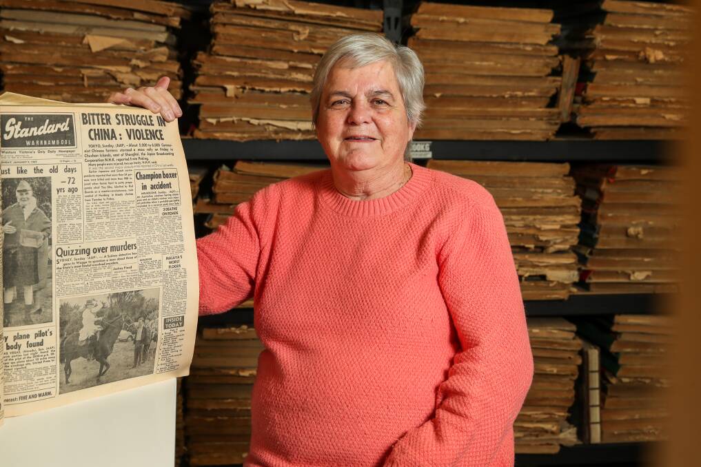 Retirement: Liz Cozens with the front page of the paper on the day she started work at The Standard in 1967 - a career that lasted 55 years. Picture: Morgan Hancock