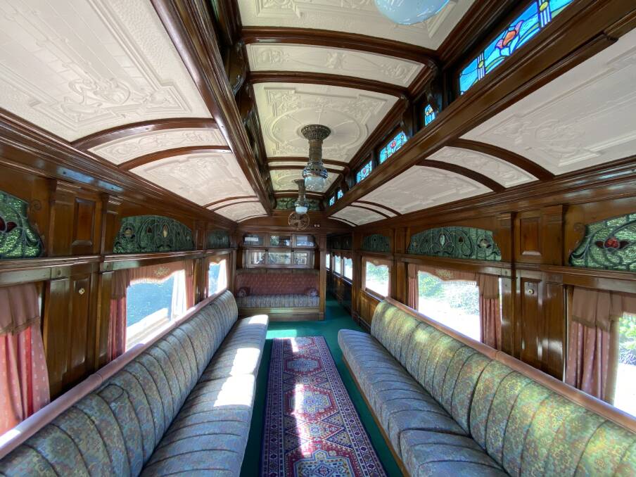 Inside the opulent lounge area of the parlor car at the rear of the train. Pictured at the end is an old photo of Hopkins Falls.