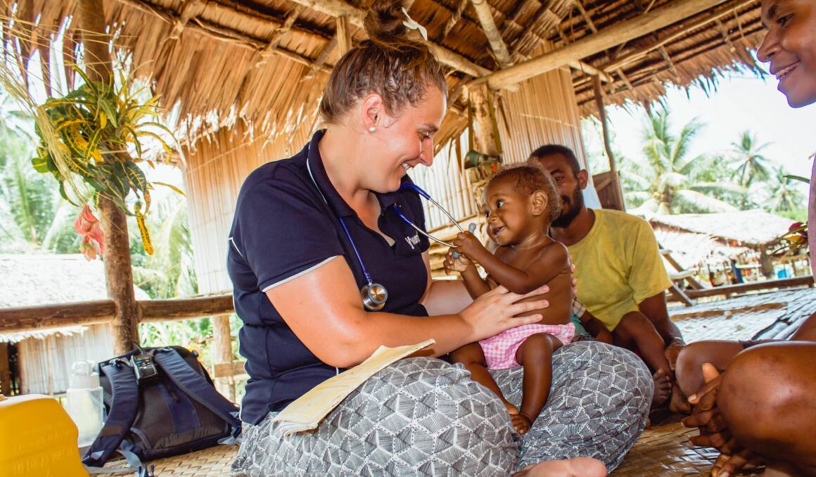 Rachel Bakker carries out a health check on a baby in PNG.