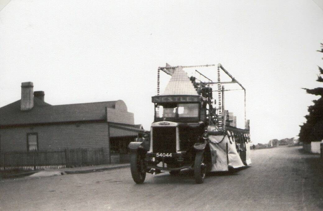 Flashback: A decorated Nestle's Truck drives past the Dennington Shop in 1926. 