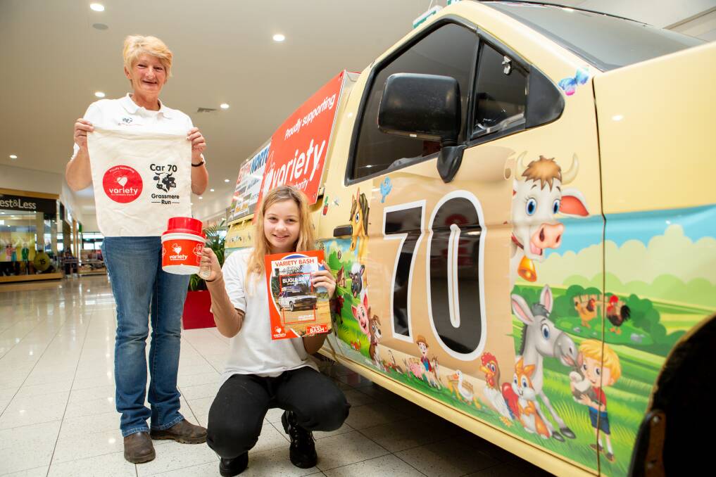 Fundraiser: Cathy Anderson, with the help of Milly Tate, 12, is raising money for Australia's most famous motor charity Variety Bash by getting kids to put stickers her car. Picture: Chris Doheny 
