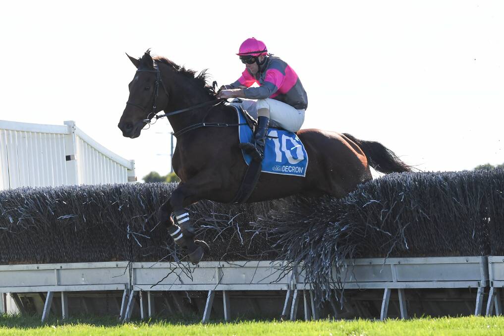 CLEAR RUN: Georgethefifth, ridden by Clayton Douglas and trained by Warrnambool's Symon Wilde, clears a hurdle in race five. Picture: Pat Scala/Racing Photos