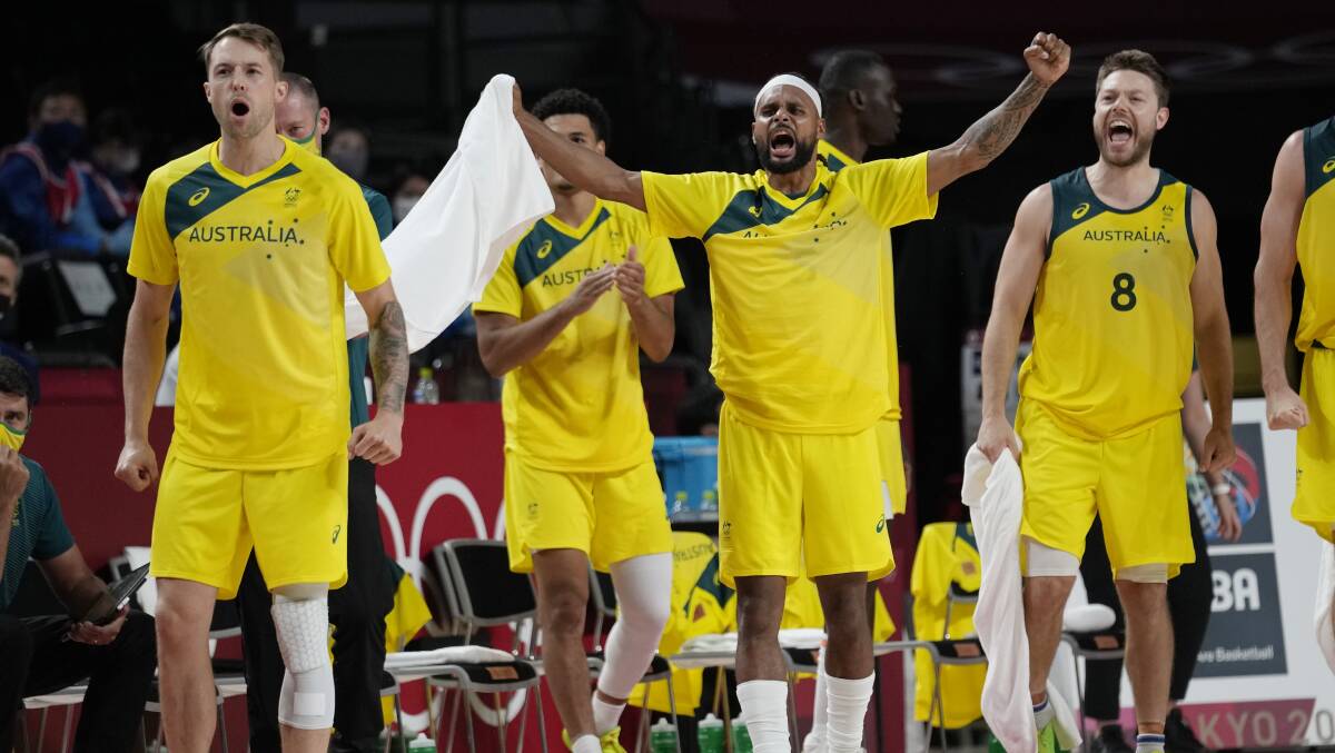 YES!: Nathan Sobey (left) celebrates with Patty Mills (centre) and Matthew Dellavedova. Picture: AAP