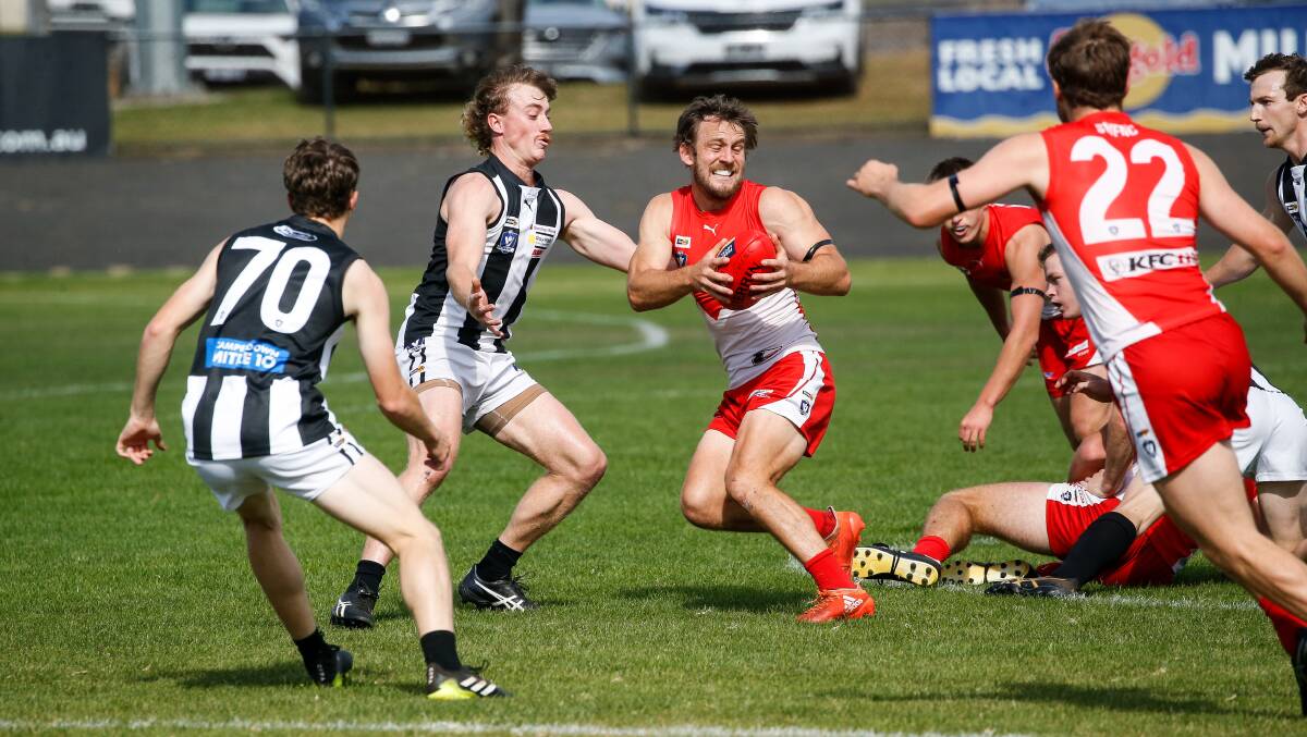 WORKING HARD: South Warrnambool's Josh Saunders evades a tackle. Picture: Anthony Brady