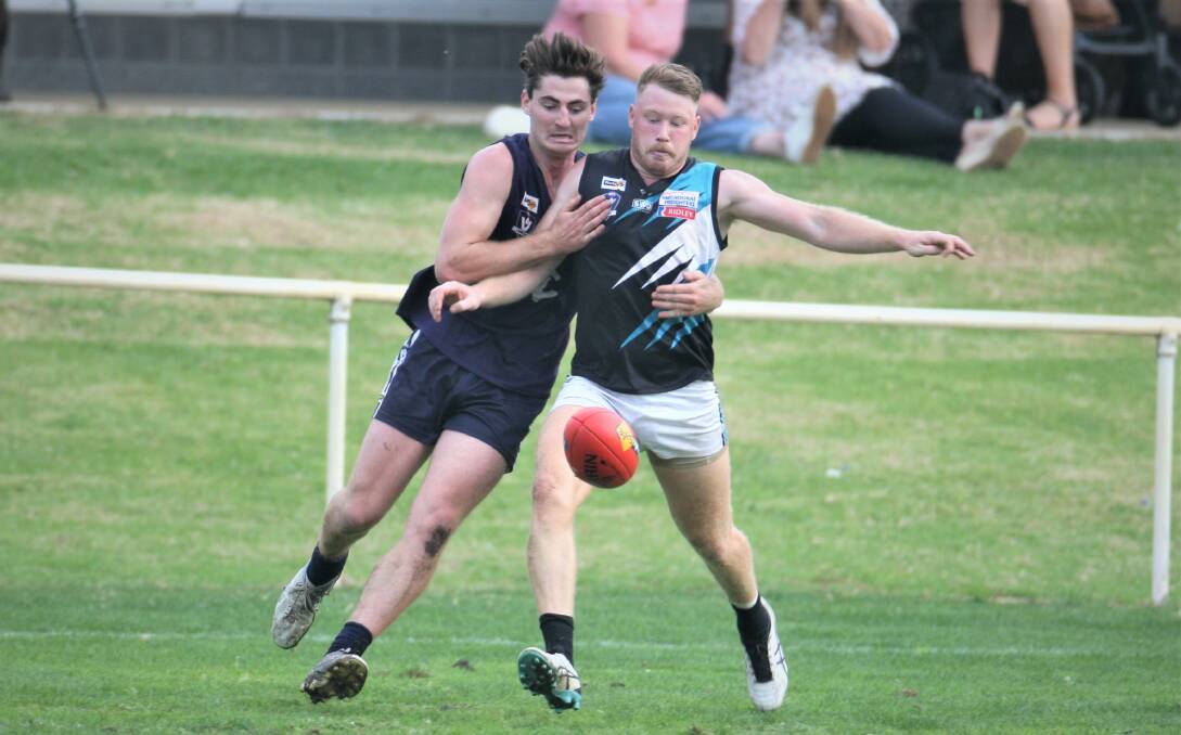 WRESTLING: Scott Carlin and Luke Tebble push and shove for the footy. Picture: Nick Ansell