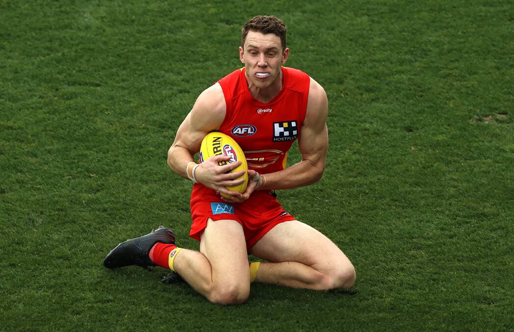 IMPRESSIVE CAMPAIGN: Gold Coast Suns' Josh Corbett takes a sliding mark in one of his 15 games in 2021. Picture: Getty Images