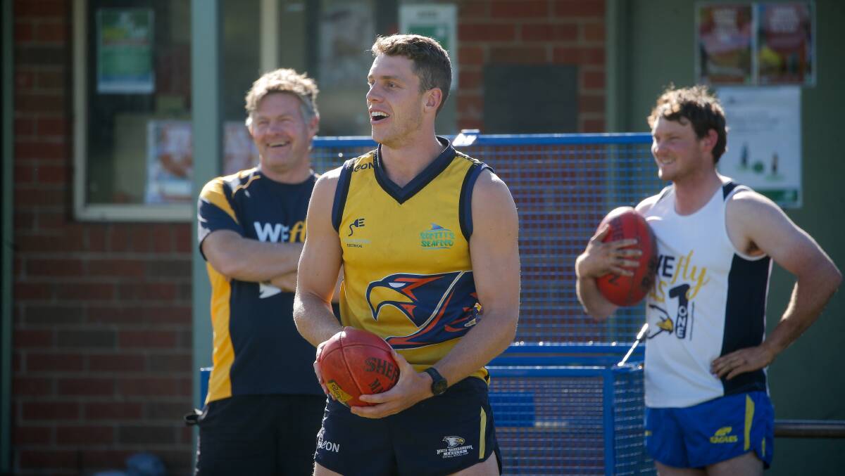 ALL SMILES: Josh Corbett has a laugh with North Warrnambool Eagles coach Adam Dowie (left) during a visit to his home club during the AFL off-season. Picture: Anthony Brady 