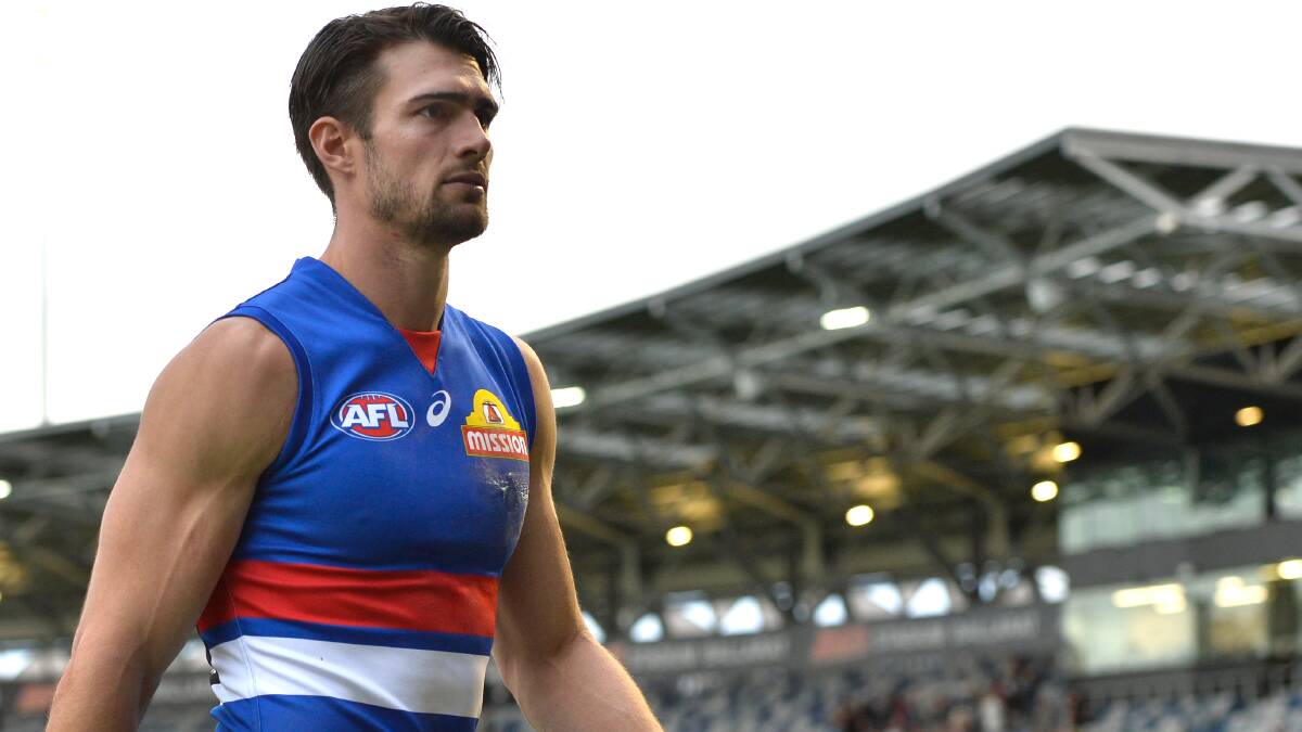 DEVASTATED: Easton Wood leads the Western Bulldogs from the field. Picture: Adam Trafford