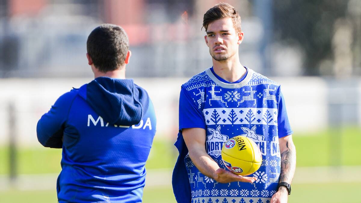 HARD CHAT: Jy Simpkin chats at North Melbourne training. Is footy in trouble? Picture: Morgan Hancock