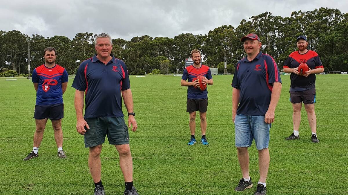 NEW START: Dennis Hobbs (second from left) has been appointed Timboon Demons' senior coach. Players Ash Rosolin (left), Ben Newey (centre), president Brendan Hickey (second from right) and Marcus Hickey (right). Picture: Timboon Demons