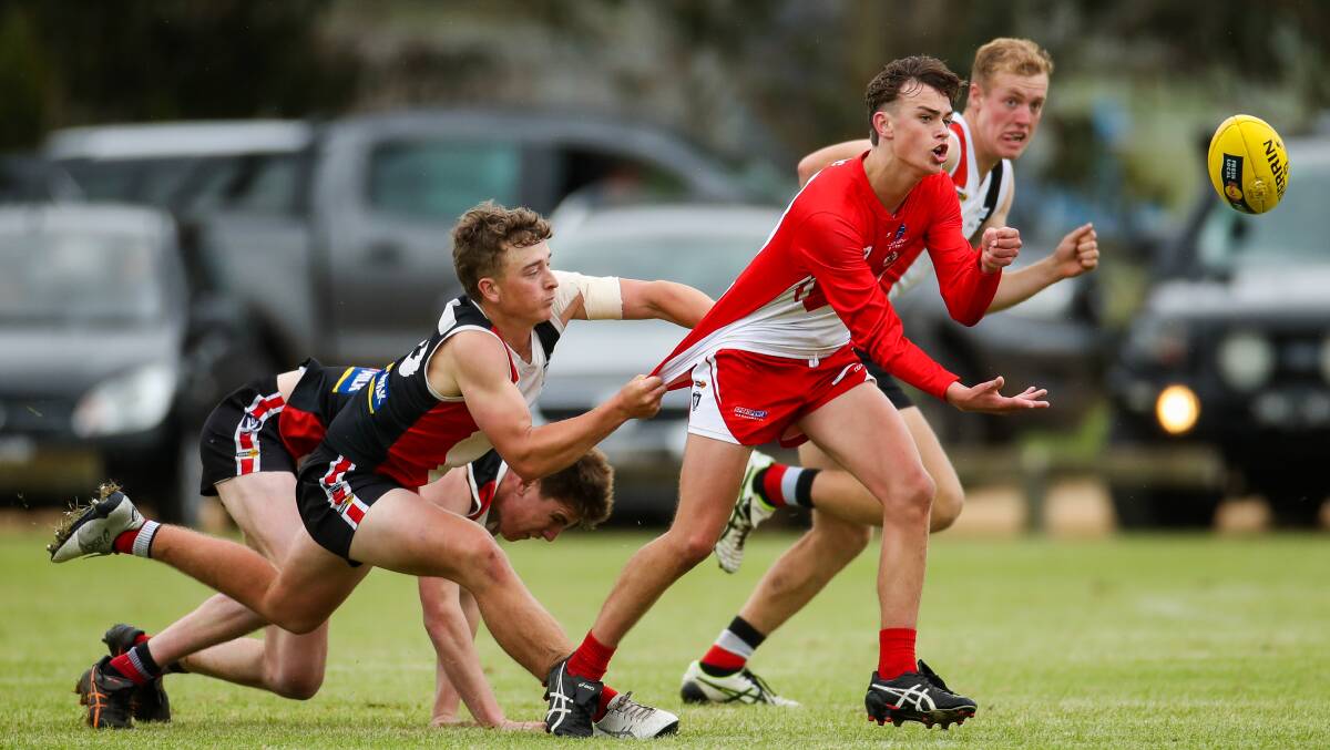 South Warrnambool's Will White fires off a handpass under pressure. Picture: Morgan Hancock 