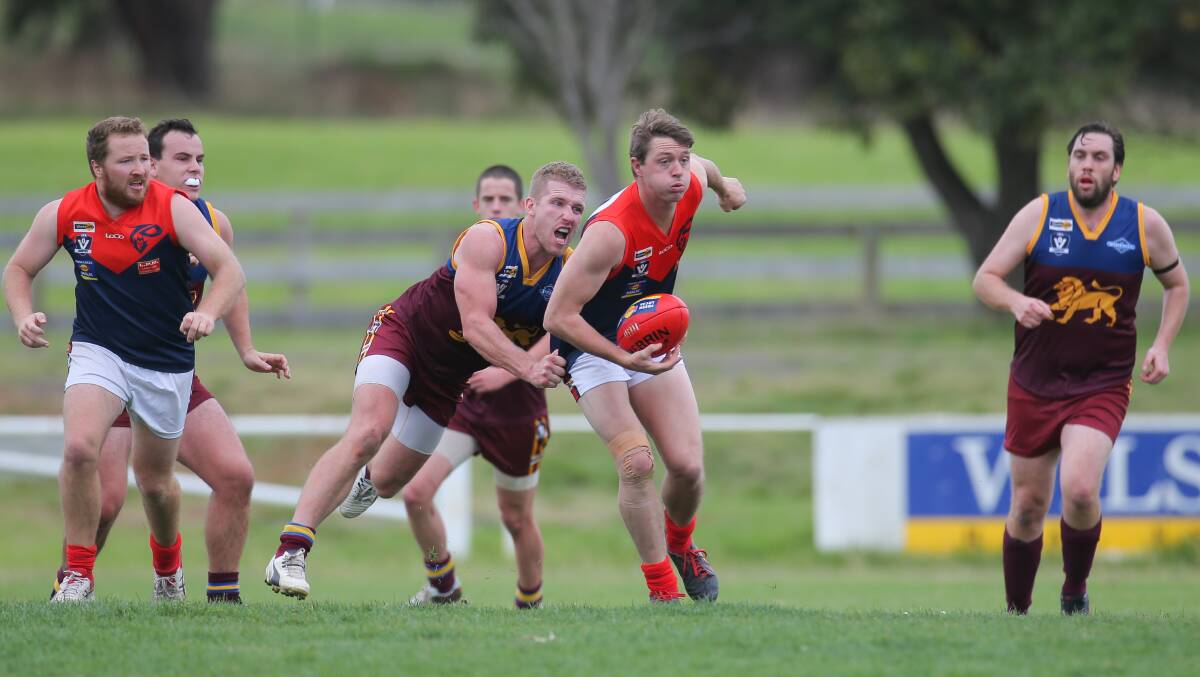 GETTING A GRIP: Timboon Demons' Rob Jewell gets away from South Rovers' Braden Hotker. The WDFNL has voted to reinstate the under 17.5 substitute rule.