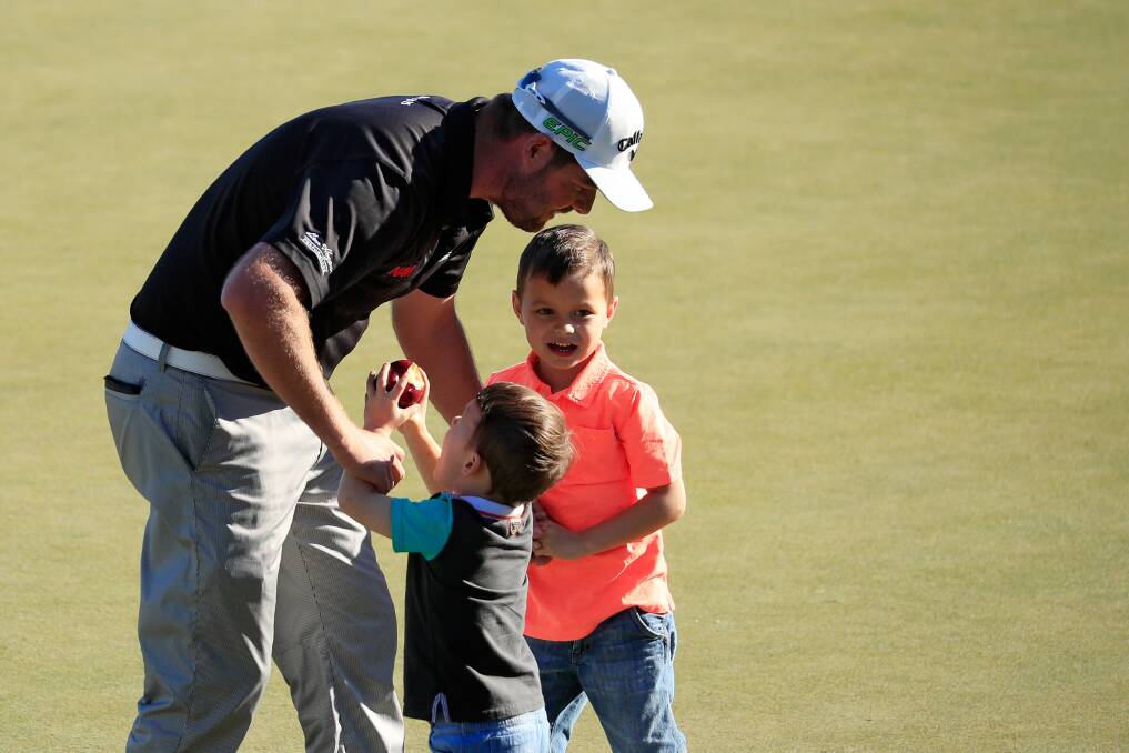 Marc Leishman of Australia celebrates with his children Oliver and Harry after finishing on the 18th green during the final round of the Arnold Palmer Invitational. Picture: Getty Images