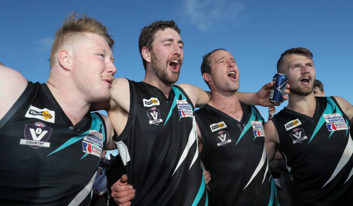 PROUD: Kolora-Noorat players, including Luke Tebble (left), sing the song after their grand final victory.