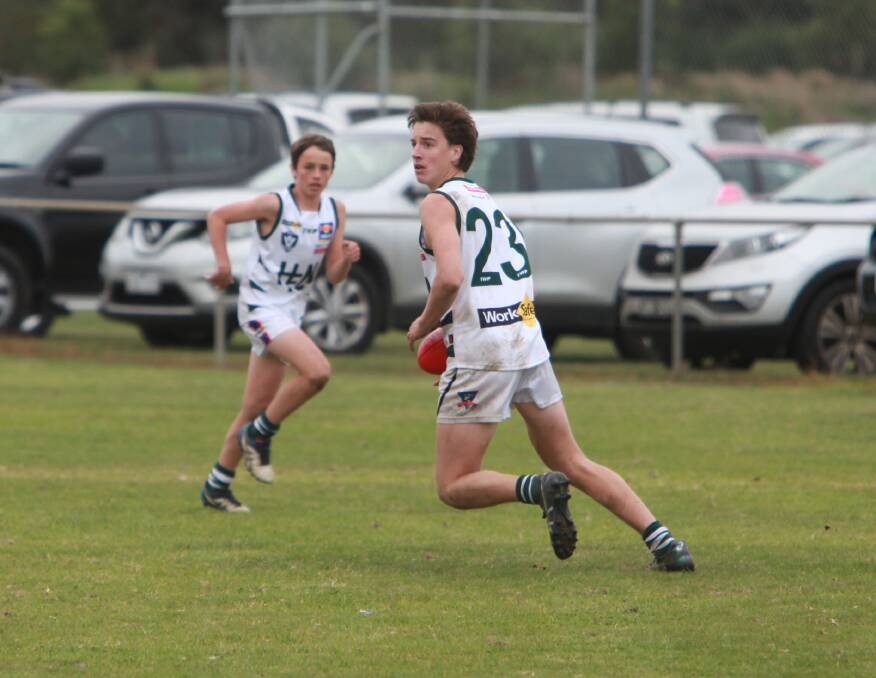 PICK THE PASS: Warrnambool's Angus Bade searches for an option while playing for Hampden White in the under 14 grand final. 