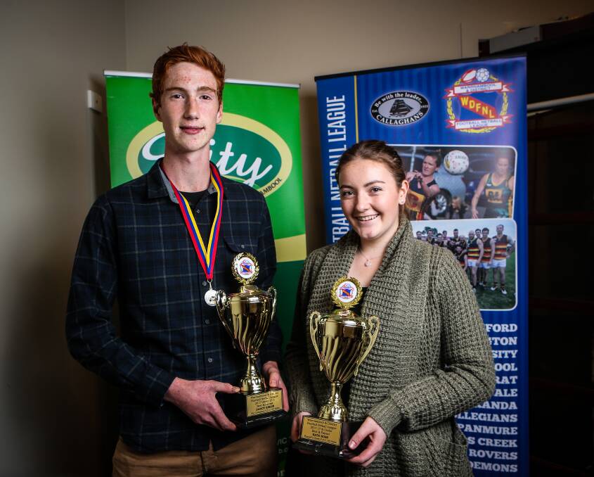 PROUD MOMENT: Warrnambool and District under 17.5 football winner Darcy Giblin alongside 17 and under netball winner Kate Ross. Picture: Christine Ansorge
