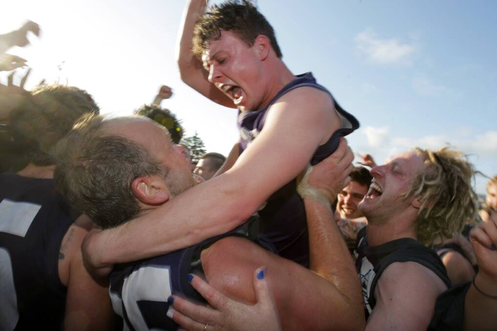 Nirranda's Jason Lee gets lifted high by his teammates after the club's victory over Old Collegians in the Grand Final. Picture: Rob Gunstone