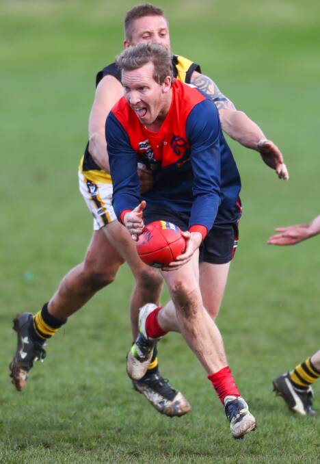 OUT OF REACH: Timboon Demons' Andrew Clements running from Merrivale's Jason Rowan. Picture: Morgan Hancock