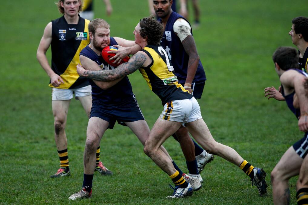  Nirranda's Tyler Coates tries to fend off the tackle of Merrivale's Sam Gleeson. Picture: Rob Gunstone