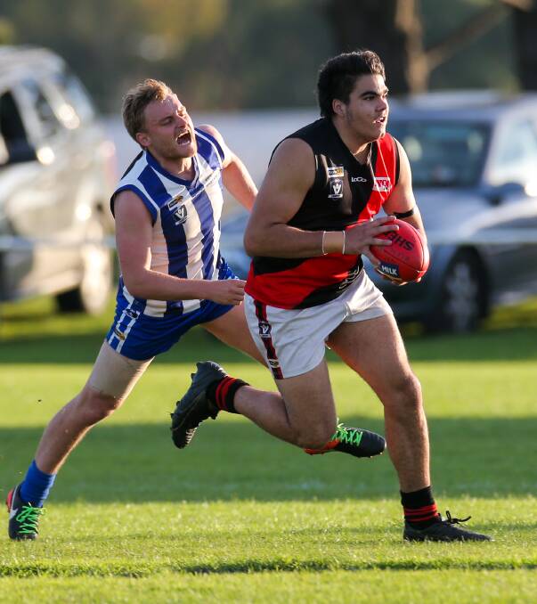 EXPLOSIVE: Phillip Chatfield Jnr bursts out of the centre with the ball, as Russells Creek's Andrew McMeel gives chase. Picture: Rob Gunstone