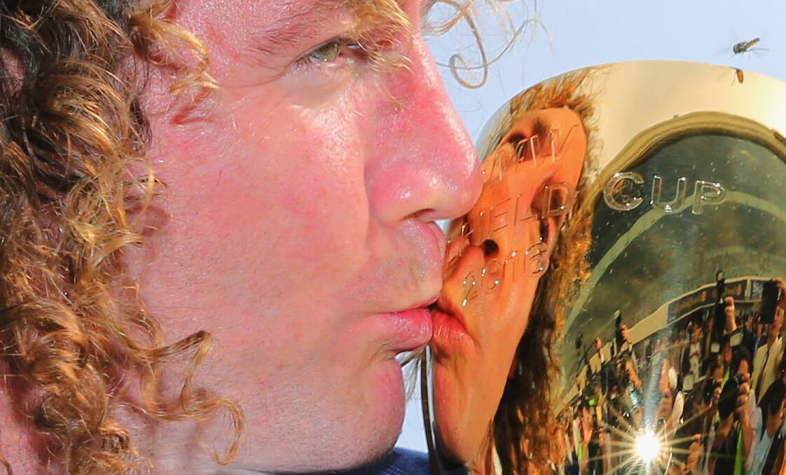 SMOOCH: Winslow-raised trainer Ciaron Maher kisses the Caulfield Cup after his mare Jameka triumphed in front of a packed house. Picture: Getty