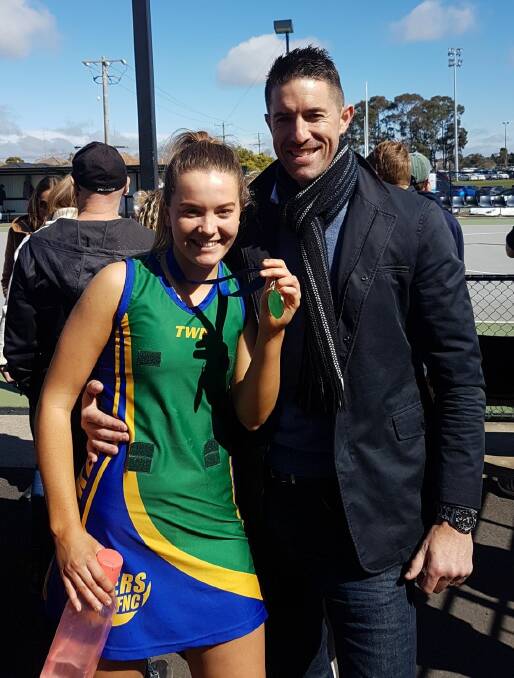 Check it out: Amelia and Matt Monk stand proud as punch after Amelia helped Lake Wendouree to premiership glory in the Ballarat league under 19 grand final.