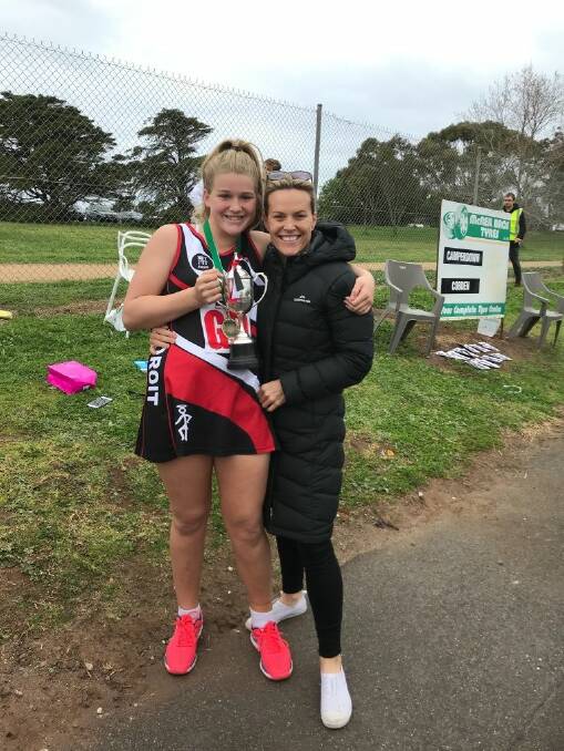 Special moment: Layla and Tayla Monk get a photo with the premiership cup after Layla was named best on court in Koroit's 15 and under Hampden league grand final win.