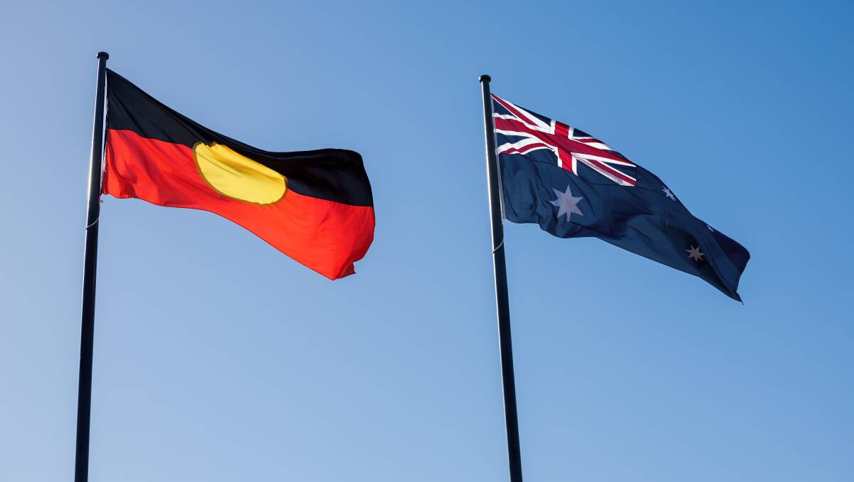 The Aboriginal flag and the Australian flag flying side by side Picture by Sitthixay Ditthavong