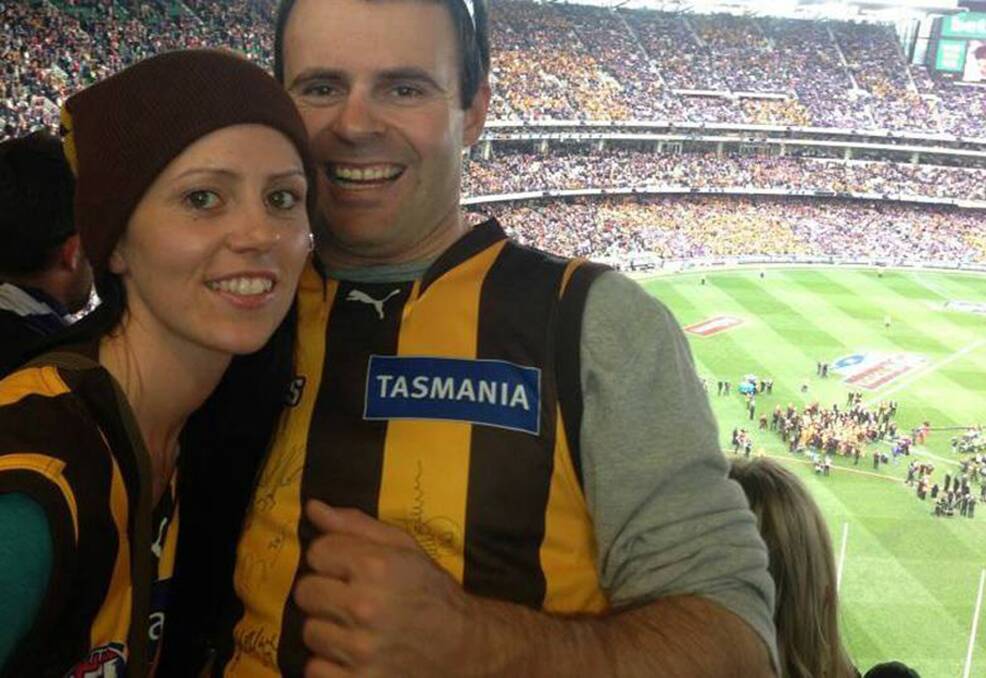 Game-on: Carly and husband Beau at the MCG supporting their beloved Hawks in September 2013