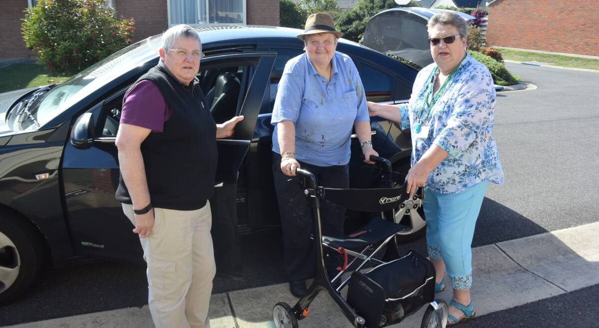 AT YOUR SERVICE: ConnectU Manager Brenda Hampson assists Leonie Roberts into the car driven by volunteer Gail Rutter. Picture: Rebecca Riddle