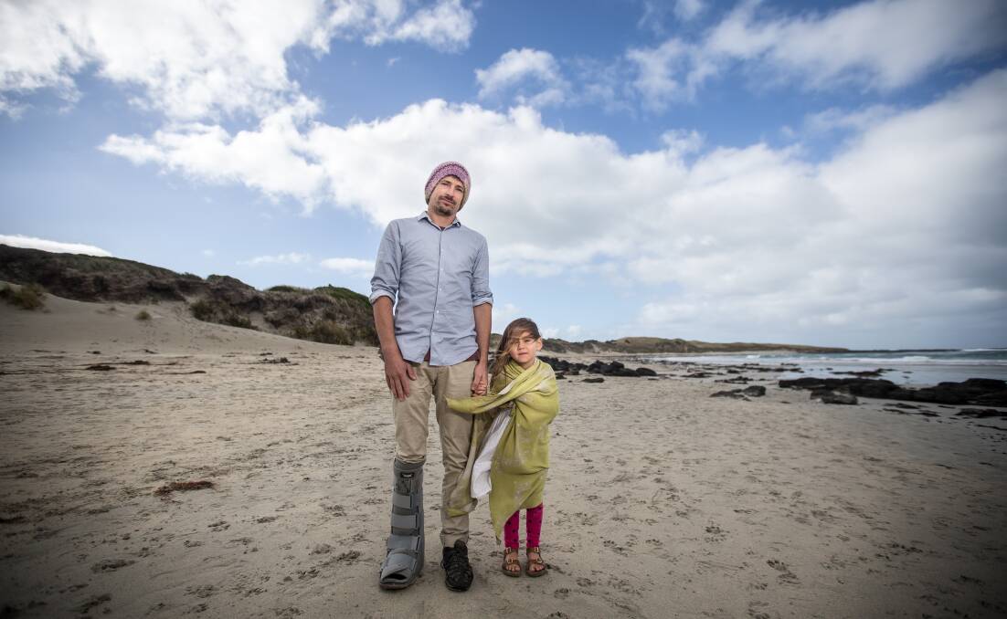 HANDS ON: Port Fairy surfer Ben Druitt and daughter Ymai, 4 are hoping hundreds will join them at Saturday's 'hands Across the Sand' event at South Beach. Picture: Christine Ansorge.