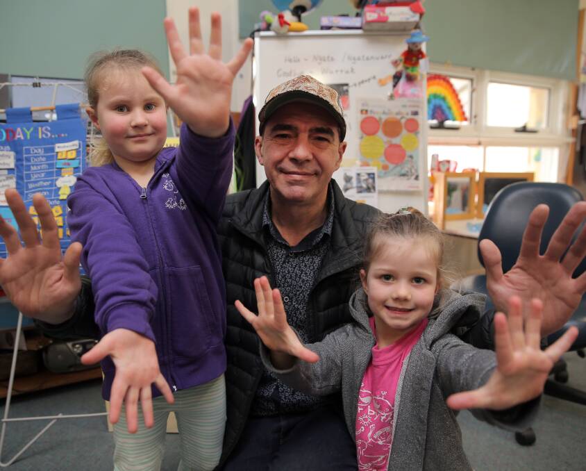 Learning fun: South Warrnambool Kindergarten's Maisy Rowe, 5 (left) and Isabel Divall, 5, hold up their marrang (hands) after learing the names of different body parts. Picture: Rob Gunstone