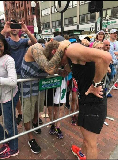 Support: Mr Ansell receives congratulatory support from friends as he limps his way across the finish line of the 2017 Boston marathon.