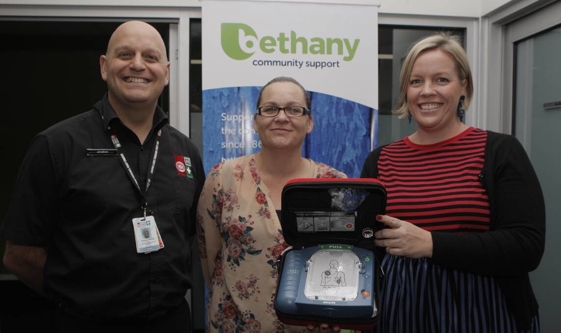 Heartfelt: St Johns instructor Jonathon Barge was guiding Bethany Community Support staff Danielle Lavithis and Kristie Low in the use of their new defibrillator earlier this week. Picture: Anthony Brady.