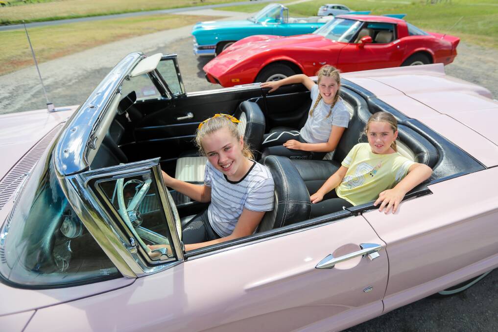 Cruisin: Warrnambool's Ailish Murfett, 12, Mataya Murfett, 10, and Rielle Murfett, 8, are tickled pink to be having a preview of some of the American beauties on offer at this weekend's Lake Pertobe event. Picture: Morgan Hancock