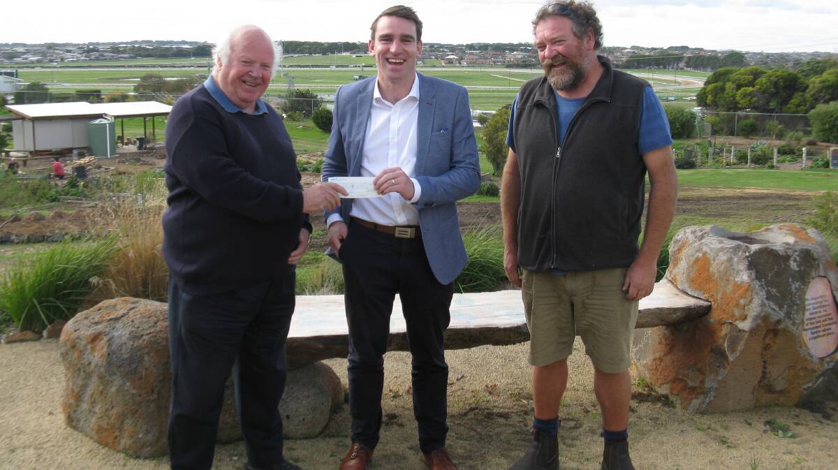 Neighbours: Community Garden Treasurer, Mr. Peter Jackman was all smiles when he received a cheque from Warrnambool Racing Club CEO Mr. Peter Downs at the garden last week. Pictured here with garden founding member, Mr David Mitchell.