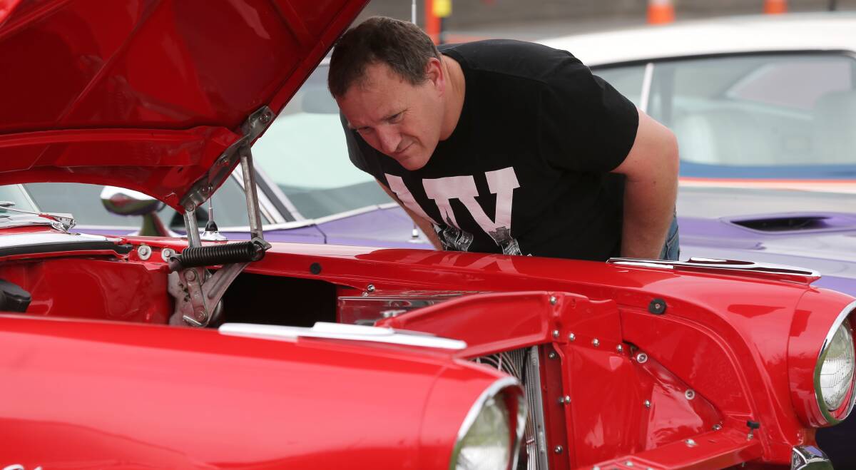 For the love of cars: Cameron Arms, of Warrnambool, was busy keeping an eye on the details when inspecting the engine of a Pontiac Star Chief at the Kruisin Classics car show on the weekend. Picture: Rob Gunstone