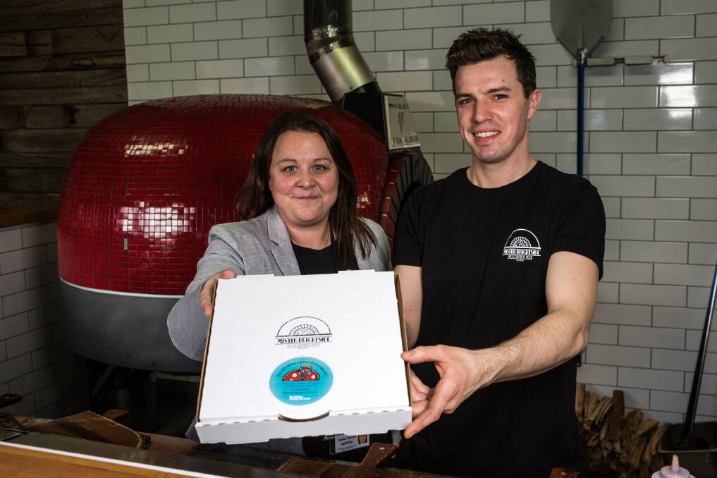 Yum: MacKillop Family Services' Tania Ferris and Mr Brightside owner Jarrod McSween are urging pizza-lovers to consider sharing their dinner and their home with kids in need. Picture: Christine Ansorge.
